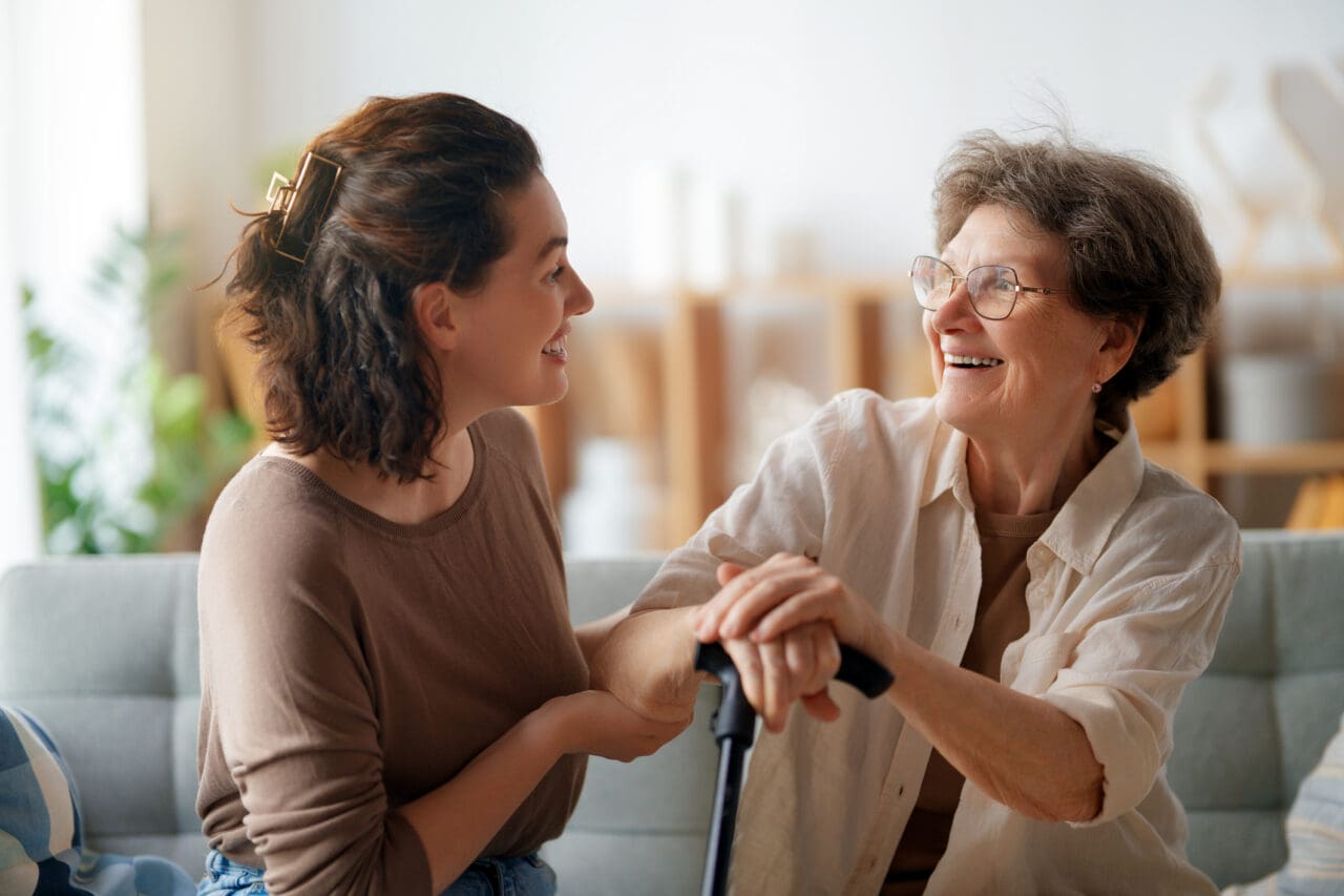 A senior with her caregiver discussing Medicare insurance
