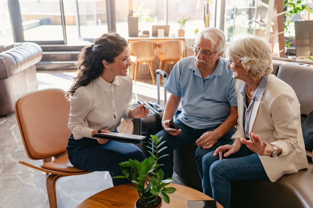 Medicare insurance agent educating elderly couple on regulatory changes
