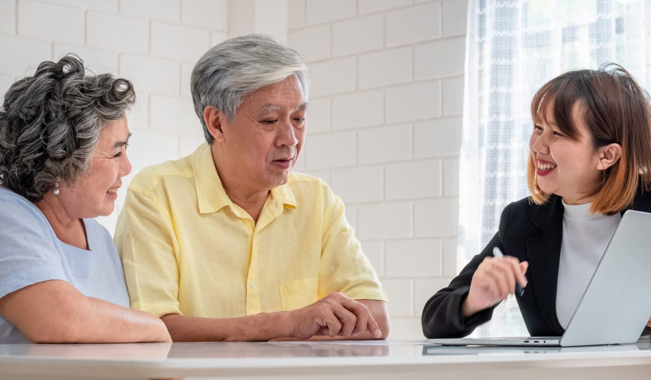 Elderly couple speaking to Medicare insurance agent