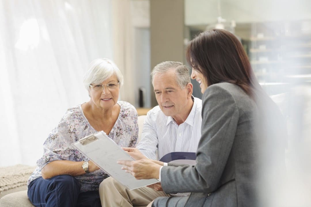 Medicare insurance agent consulting a senior couple about plans