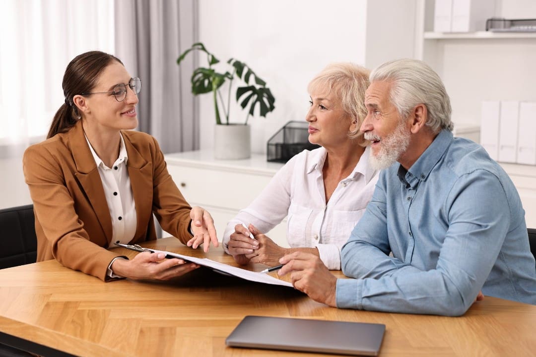 Medicare insurance agent explaining coverage to a senior couple